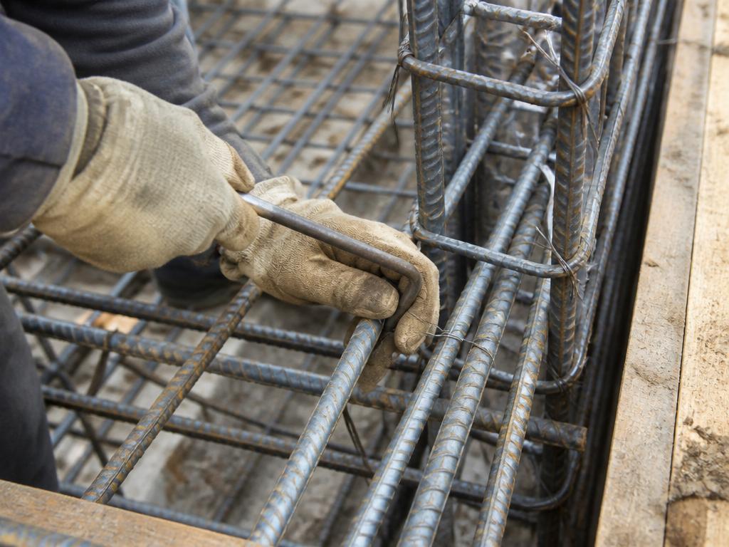 Ironworker tying rebar with wire